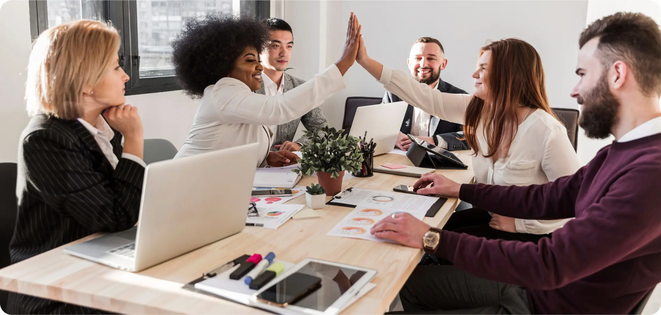 Diverse group of employees smiling and laughing in a sustainable workplace